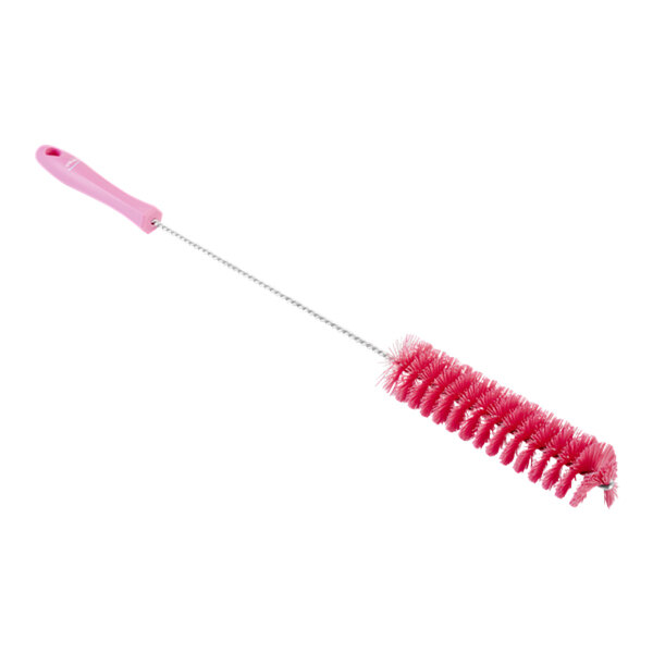 A close-up of a pink Vikan stiff polyester tube brush with a handle.