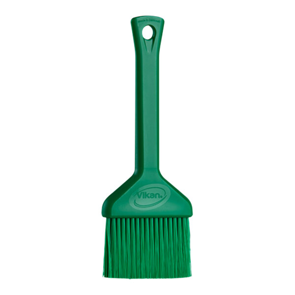 A Vikan green plastic pastry brush with a green handle.