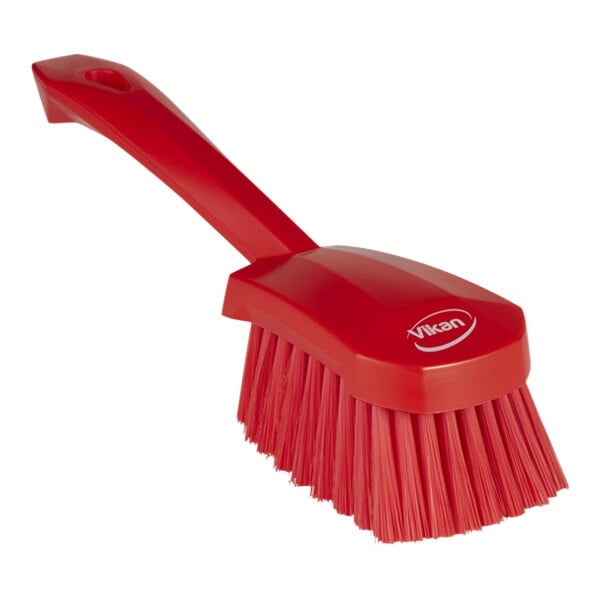 A red Vikan washing brush with a handle.