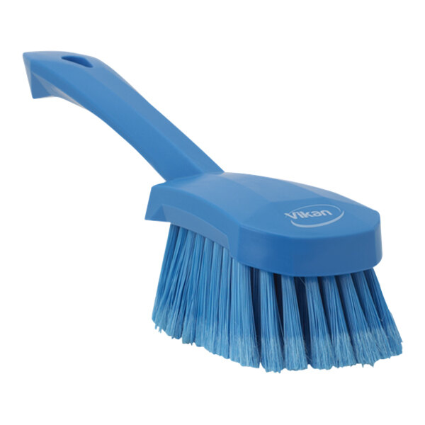A Vikan blue washing brush with a short handle.
