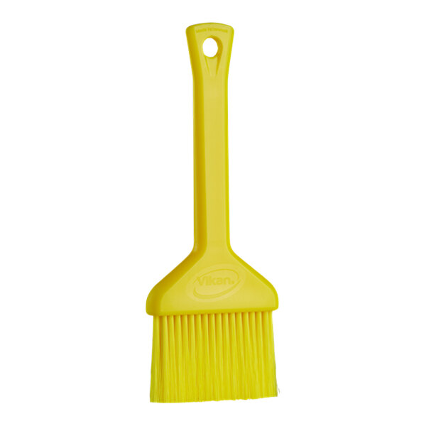 A Vikan yellow plastic brush with a handle.