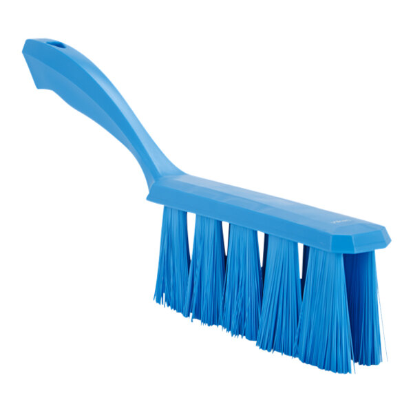 A close-up of a blue Vikan bench brush with long bristles.