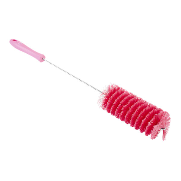 A Vikan pink tube brush with a long handle.