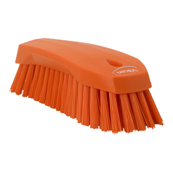 An orange Vikan scrub brush with a handle.