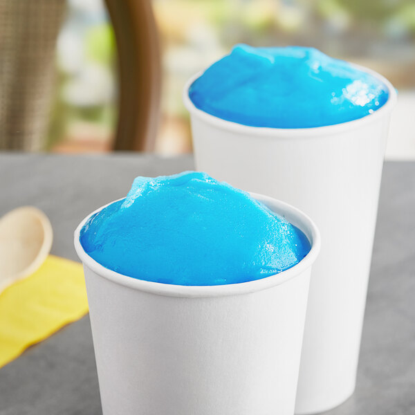 Two cups of blue Philadelphia Water Ice on a table.