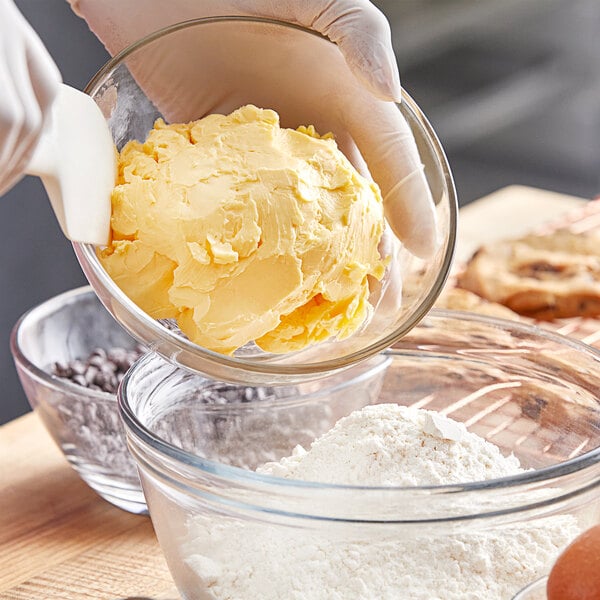 A person mixing Stratas Buckeye Flex Baker's Margarine Shortening in a bowl.