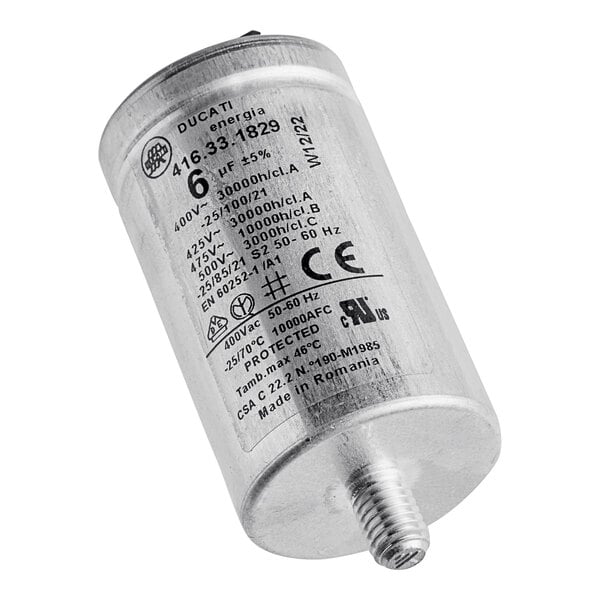 A silver metal capacitor with black text on a white background.