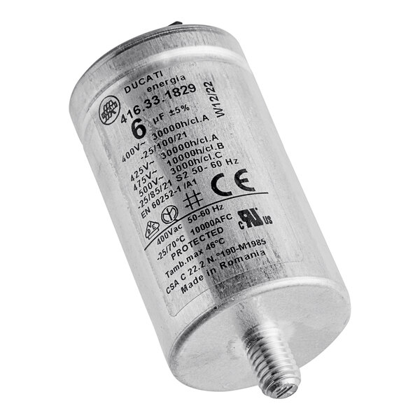 A silver metal capacitor with black text on a white background.