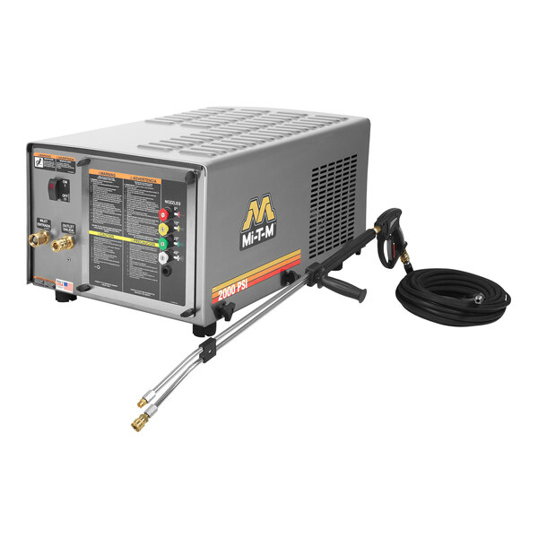 A Mi-T-M corded electric cold water pressure washer machine on a table with switches and a hose.