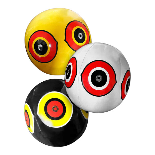 A close-up of a yellow and white ball with red and black circles with eyes on it.