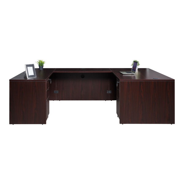 A Boss mahogany laminate desk with dual storage pedestals and a laptop on it.