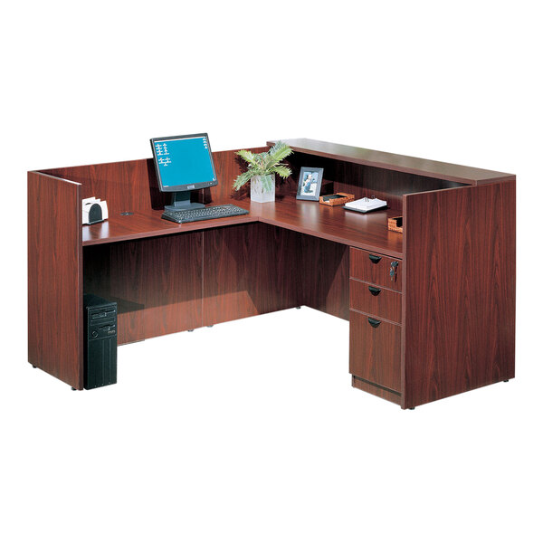 A Boss mahogany desk with a computer and monitor on it.