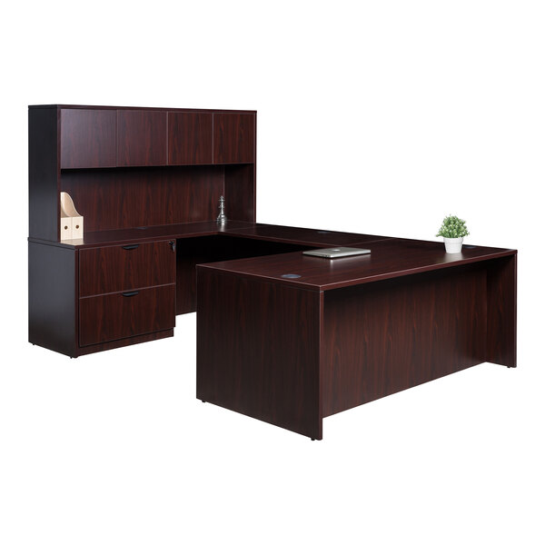 A Boss mahogany laminate desk with lateral storage cabinet and hutch on top with a plant on it.