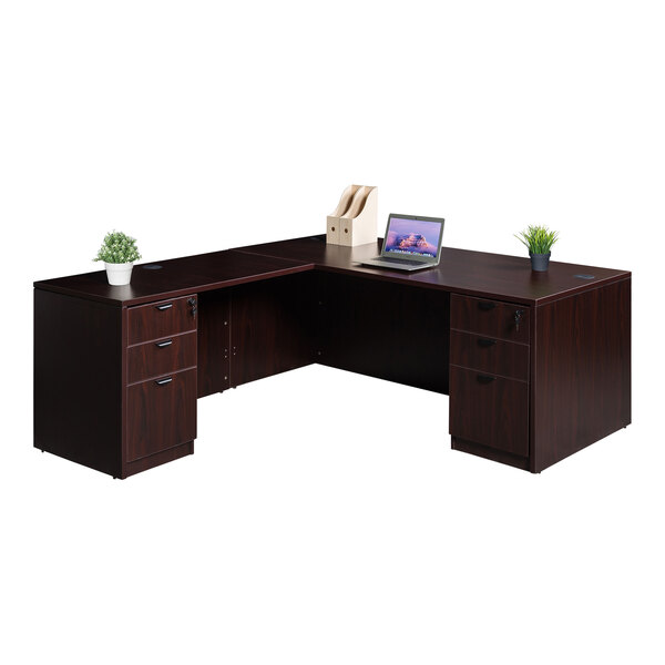 A Boss mahogany laminate L-shaped desk with dual storage pedestals and a laptop on it.