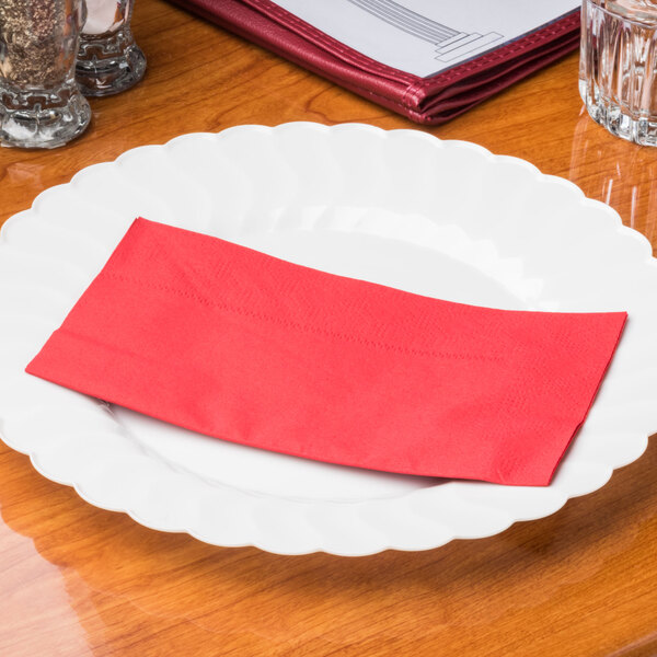 A red Hoffmaster paper napkin on a white plate.