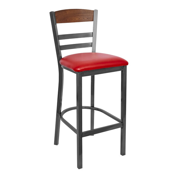 A BFM Seating clear coated steel bar stool with a red vinyl seat and autumn ash wood back.