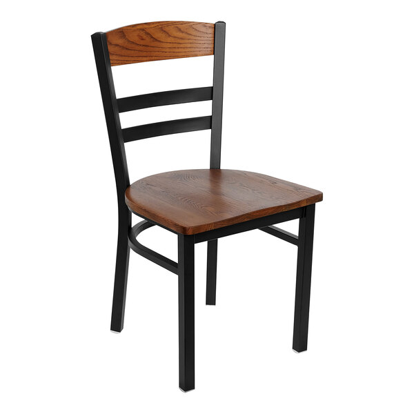 A BFM Seating side chair with a wooden seat and back panel and black frame.