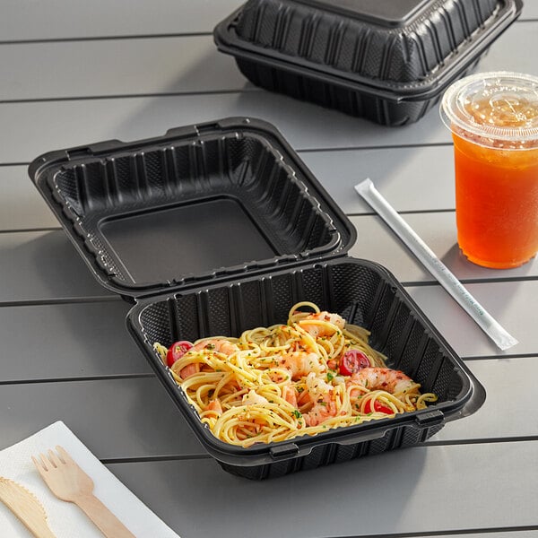 A black Choice plastic container with food in it.