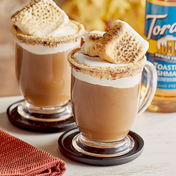 Two mugs of hot chocolate with toasted marshmallows on top using Torani Sugar-Free Toasted Marshmallow Flavoring Syrup.