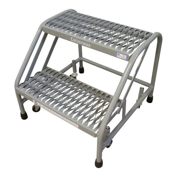 A grey Cotterman steel mobile step stand with two steps and wheels.