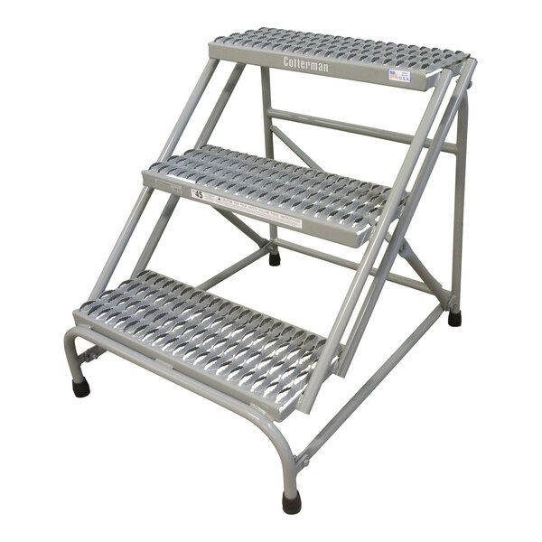 A gray powder-coated metal Cotterman 3-step ladder with metal steps.