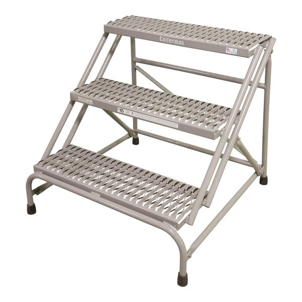 A gray metal Cotterman 3-step industrial ladder.