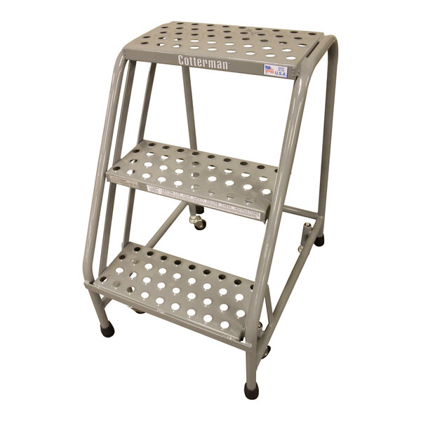 A Cotterman gray powder-coated steel rolling ladder with perforated steps.