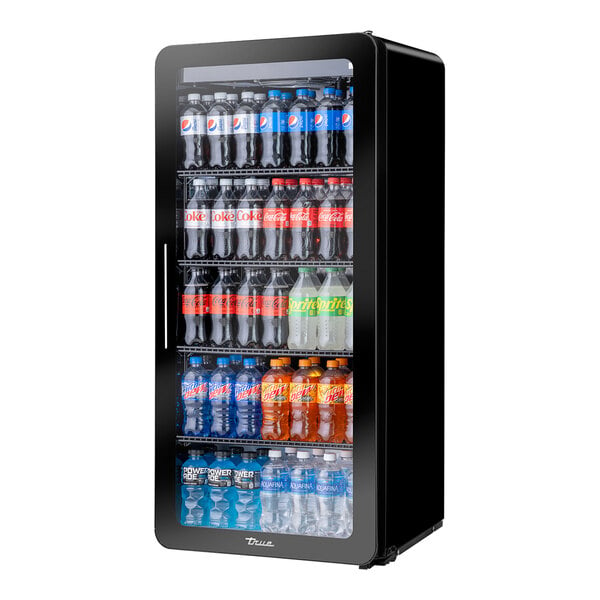 A black True refrigerated glass door merchandiser full of soda bottles.