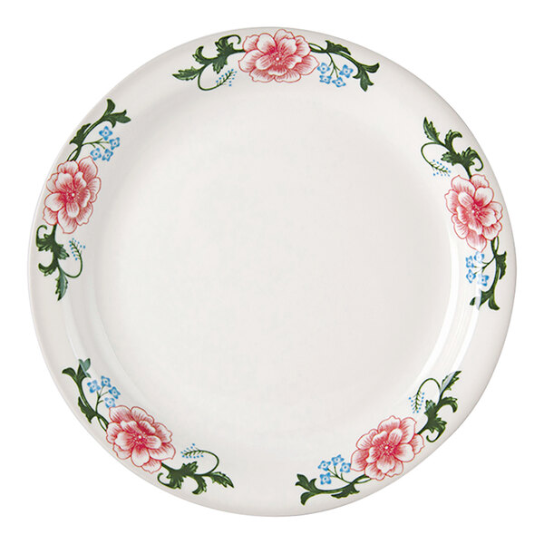 A white Tuxton China plate with pink flowers and a narrow rim.
