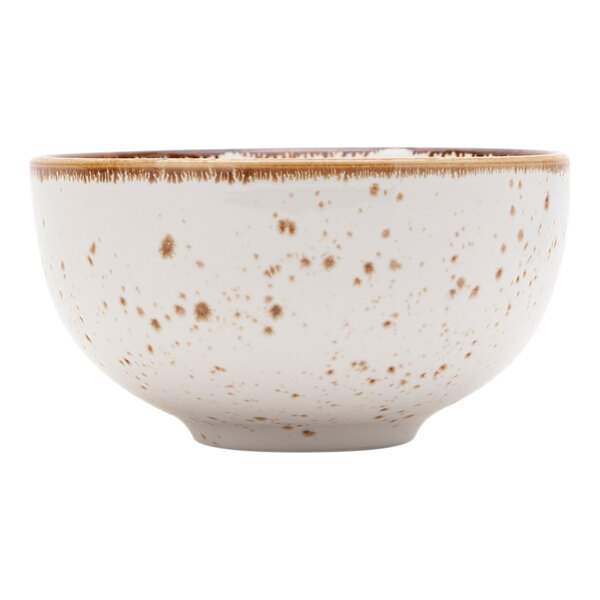 A white bowl with brown speckles on it.