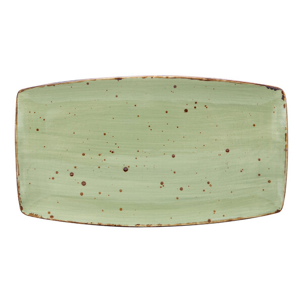 A white rectangular Tuxton china plate with green and brown specks.