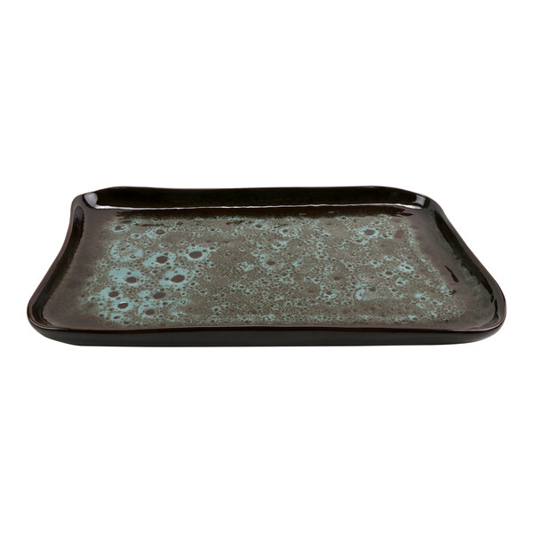 A black and brown rectangular terracotta tray with a design on it.