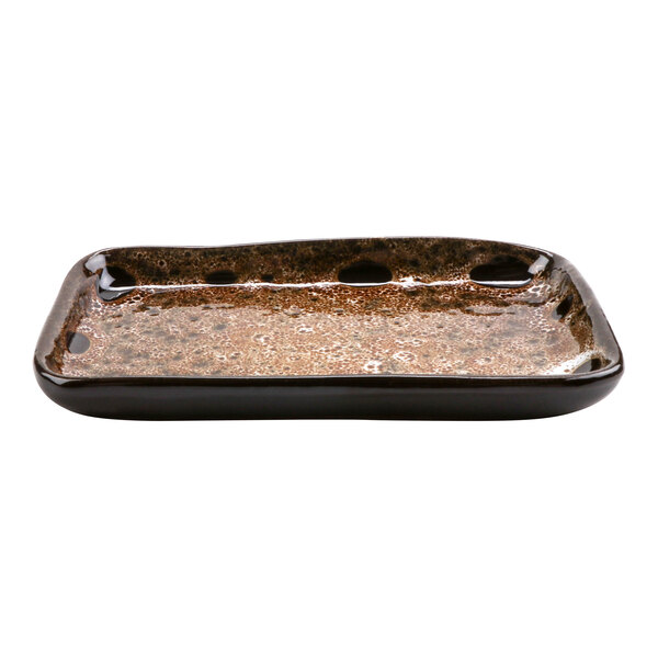 A rectangular brown cheforward terracotta tray with black and brown spots.