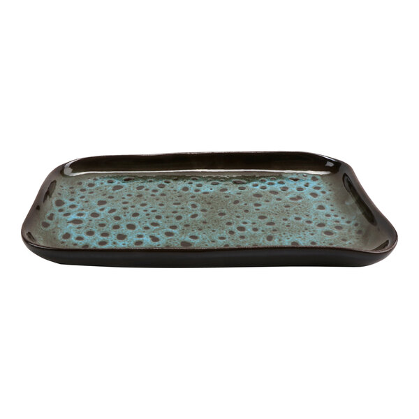 A cheforward rectangular terracotta tray with a black and blue speckled surface.