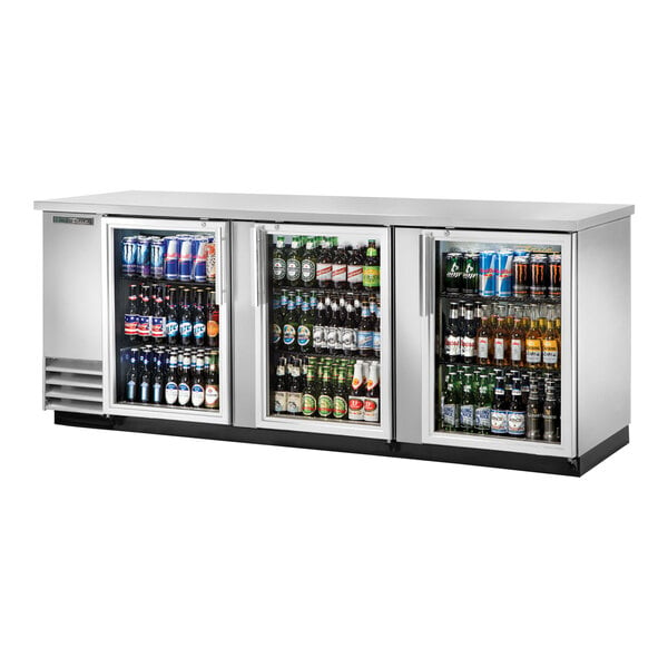 A True back bar refrigerator with glass doors filled with drinks and beverages.
