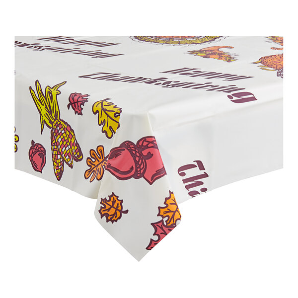 A white Table Mate plastic table cover with fall designs including turkeys and leaves.