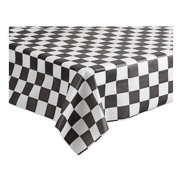 A black and white checkered Table Mate plastic table cover on a table.