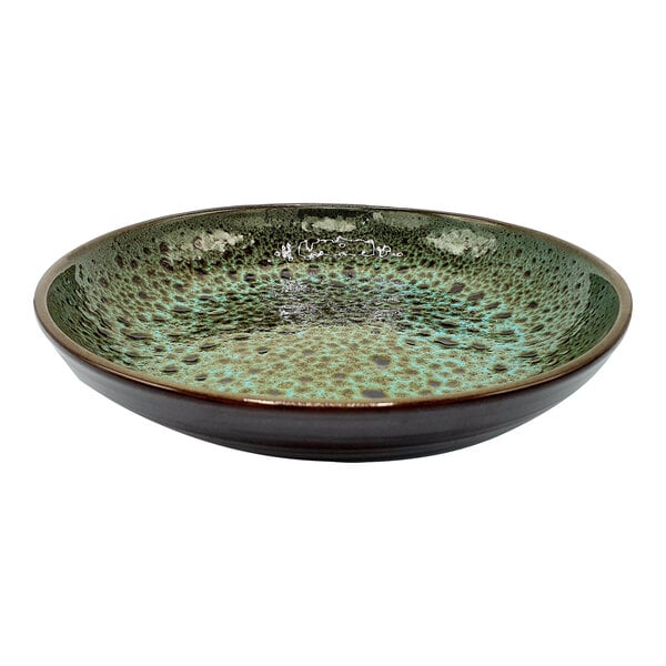A close up of a cheforward terracotta soup bowl with a green and brown speckled design.