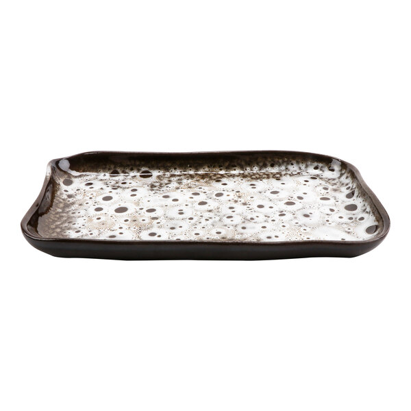 A rectangular terracotta tray with a white and black speckled surface.
