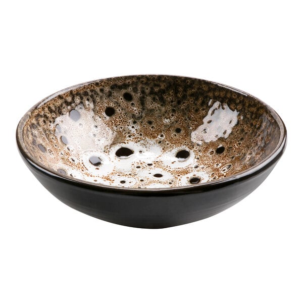 A cheforward terracotta bowl with a brown and white surface.