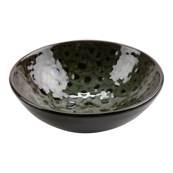 A terracotta bowl with a speckled design.