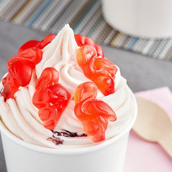 A cup of ice cream with Vidal pink flamingo gummies on top.