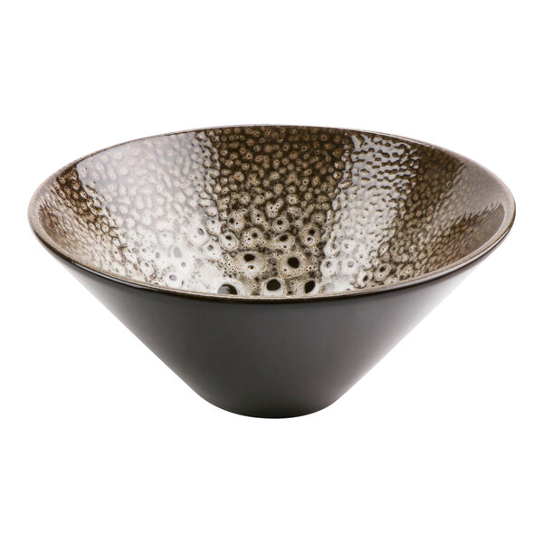 A cheforward terracotta bowl with a white and black speckled surface.