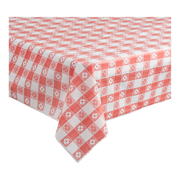 A close-up of a red and white checkered Table Mate plastic table cover on a table.