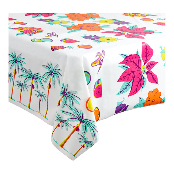 A Table Mate floral luau plastic table cover roll with tropical designs on a table.