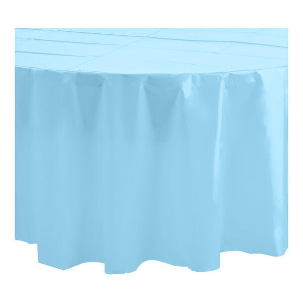 A white round table with a light blue Table Mate plastic table cover.