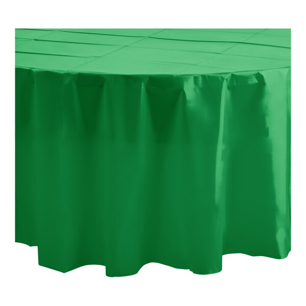 A green Table Mate plastic tablecloth on a round table.