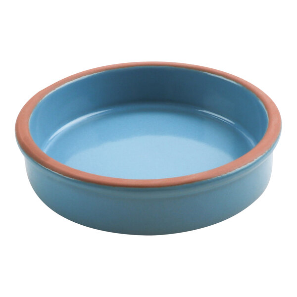 A blue terracotta casserole dish with a brown rim.