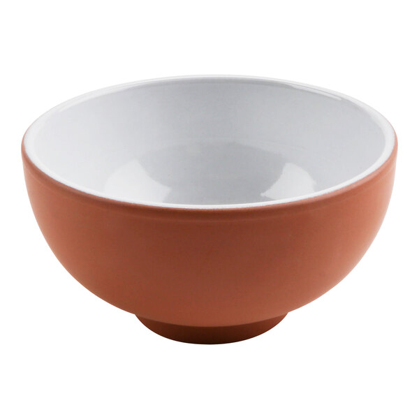 A white terracotta bowl with a white rim and brown surface.