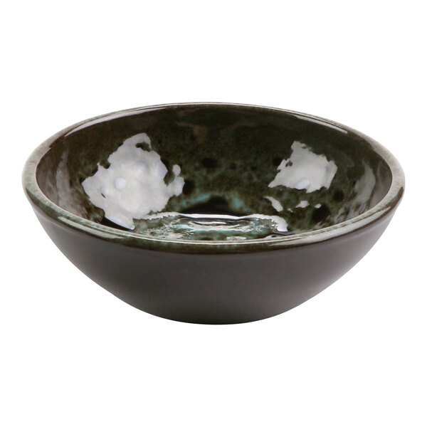 A terracotta bowl with a white surface and a black and white design.
